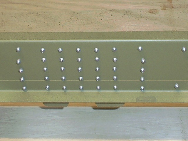 Rear attachment plate rivet shop heads.  Very consistant work done with air riveter.