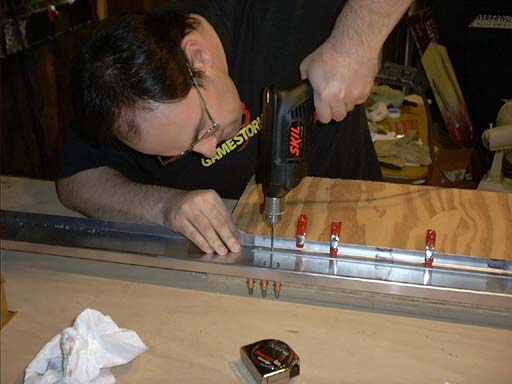 Drilling out the holes for the lower doubler.  Notice I'm basically aligned with the upper clecoes, and I need a haircut